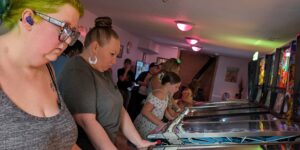 women playing pinball
